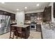 Modern kitchen features stainless steel appliances, dark wood cabinets, and a center island at 47 Gloster Mill Way, Lawrenceville, GA 30044