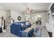 Inviting living room with plush gray carpet, a blue sofa, and a view into the dining area at 47 Gloster Mill Way, Lawrenceville, GA 30044