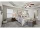 Comfortable main bedroom with a tray ceiling and carpet flooring at 47 Gloster Mill Way, Lawrenceville, GA 30044