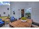 Outdoor patio area featuring a wooden table with chairs, cozy cushions, and view of the backyard at 508 Regency Trl, Acworth, GA 30102