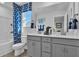 A modern bathroom with double sinks, vanity and a shower-tub combo with stylish blue curtains at 508 Regency Trl, Acworth, GA 30102