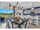 A modern dining area featuring an island and a stylish light fixture over a table set for six at 508 Regency Trl, Acworth, GA 30102