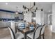 A dining area with seating for six, with modern decor and an adjacent kitchen area with stainless steel appliances at 508 Regency Trl, Acworth, GA 30102
