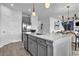 Open kitchen with island and breakfast bar, stainless appliances and hardwood floors at 508 Regency Trl, Acworth, GA 30102
