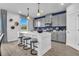 Bright kitchen featuring an island with breakfast bar, modern lighting, and stainless steel appliances at 508 Regency Trl, Acworth, GA 30102