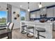 Modern kitchen boasts a large island with seating, gray cabinets, and stainless steel appliances at 508 Regency Trl, Acworth, GA 30102