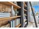 Elegant bookshelf with decorative objects, books and natural light coming from the window at 508 Regency Trl, Acworth, GA 30102
