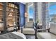 Home library boasts custom built-ins, rolling ladder, with seating area and beautiful natural light at 508 Regency Trl, Acworth, GA 30102