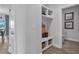 Mudroom featuring built-in shelving, storage baskets, and access to a nearby powder room at 508 Regency Trl, Acworth, GA 30102