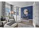 Home office featuring hardwood floors, a large window, comfortable chairs, and a blue accent wall at 508 Regency Trl, Acworth, GA 30102