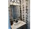 Modern powder room boasting a quartz countertop and black fixtures, creating a stylish design at 5458 Stagecoach Rd, Ellenwood, GA 30294