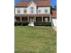Traditional two-story home with brick accents, manicured lawn, and inviting front porch at 5458 Stagecoach Rd, Ellenwood, GA 30294