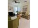 Bright living room featuring a fireplace, ceiling fan, decor, and a large window offering natural light at 5458 Stagecoach Rd, Ellenwood, GA 30294