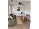 Home office space featuring a glass top table and olive colored seating with wood laminate floors at 5458 Stagecoach Rd, Ellenwood, GA 30294