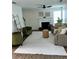 Bright living room featuring a fireplace, ceiling fan, decor, and a large window offering natural light at 5458 Stagecoach Rd, Ellenwood, GA 30294