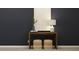 Hallway decor featuring a wooden table, stools, decorative lamp, and a painted wall at 616 Blue Sky Blvd, Acworth, GA 30102