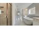 Bright bathroom featuring a soaking tub, double vanity, and a tiled shower at 76 Homesite Dulles Dr, Mcdonough, GA 30253