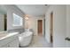 Bright bathroom featuring a soaking tub, double vanities, and a separate shower, creating a luxurious and relaxing spa-like experience at 76 Homesite Dulles Dr, Mcdonough, GA 30253