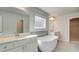 Bright bathroom featuring a soaking tub, double vanities, and a separate shower, creating a luxurious and relaxing spa-like experience at 76 Homesite Dulles Dr, Mcdonough, GA 30253