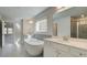 Bright bathroom featuring a soaking tub, double vanity, and a tiled shower at 76 Homesite Dulles Dr, Mcdonough, GA 30253