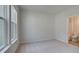 Bright bedroom featuring plush carpeting, neutral walls, and a large window offering natural light and access to an ensuite bathroom at 76 Homesite Dulles Dr, Mcdonough, GA 30253