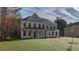 Stately two-story home with a lush green lawn and attractive architectural details at 76 Homesite Dulles Dr, Mcdonough, GA 30253