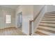 Well-lit foyer showcases beautiful stairs and a glass door entrance, adding style and function at 76 Homesite Dulles Dr, Mcdonough, GA 30253