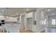 Bright, open kitchen featuring white cabinets, an island with pendant lights, and stainless appliances at 76 Homesite Dulles Dr, Mcdonough, GA 30253