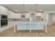 Modern kitchen featuring stainless appliances, white cabinets, island with sink, and wood-look flooring at 76 Homesite Dulles Dr, Mcdonough, GA 30253
