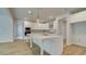 Bright kitchen featuring stainless appliances, white cabinets, an island with seating, and wood-look flooring at 76 Homesite Dulles Dr, Mcdonough, GA 30253