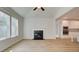 Bright living room featuring a fireplace, windows with a view, and wood-look flooring at 76 Homesite Dulles Dr, Mcdonough, GA 30253