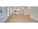 Open-concept living space with wood floors and view of kitchen beyond at 76 Homesite Dulles Dr, Mcdonough, GA 30253