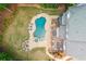 Aerial view of backyard with pool, spa, fire pit, deck, and patio area at 1100 Lady Slipper Way, Canton, GA 30115
