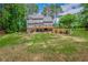 Spacious backyard with a large lawn, swimming pool, and multiple outdoor seating areas at 1100 Lady Slipper Way, Canton, GA 30115