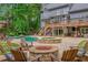 Luxurious backyard with a pool, hot tub, fire pit, and ample seating for outdoor entertaining at 1100 Lady Slipper Way, Canton, GA 30115