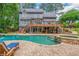 Stunning backyard showcasing a sparkling pool, spa, and an expansive wooden deck at 1100 Lady Slipper Way, Canton, GA 30115