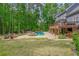 Expansive backyard featuring a pool, spa, fire pit, deck, and lush greenery at 1100 Lady Slipper Way, Canton, GA 30115