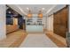 Finished basement with a stylish wet bar, wood floors and custom sliding wood door at 1100 Lady Slipper Way, Canton, GA 30115