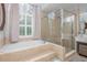Bathroom featuring a garden tub, tiled surround, and separate glass shower at 1100 Lady Slipper Way, Canton, GA 30115