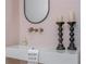 Stylish bathroom featuring modern sink with unique faucet, oval mirror and decorative candleholders at 1100 Lady Slipper Way, Canton, GA 30115