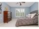 Bright bedroom with light-blue walls, white plantation shutters, and a comfortable, tufted grey bedspread at 1100 Lady Slipper Way, Canton, GA 30115