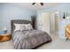 Comfortable bedroom featuring a tufted grey bedspread, a patterned pillow set, and direct access to the ensuite at 1100 Lady Slipper Way, Canton, GA 30115