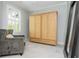 Bedroom featuring a decorative armoire, gray chair, carpet flooring, and a window with shutter-style blinds at 1100 Lady Slipper Way, Canton, GA 30115
