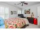 Comfortable bedroom featuring a bed, desk, ceiling fan and a window with shutter-style blinds at 1100 Lady Slipper Way, Canton, GA 30115