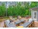 Relaxing outdoor deck features plush seating with a beautiful view of the wooded backyard at 1100 Lady Slipper Way, Canton, GA 30115