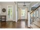 Inviting entryway featuring hardwood floors, staircase, and natural light streaming through the front doors at 1100 Lady Slipper Way, Canton, GA 30115