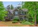 Stunning two-story home featuring a well-manicured front yard and covered front porch at 1100 Lady Slipper Way, Canton, GA 30115