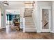 Grand foyer featuring hardwood floors, staircase, and a glimpse into the formal dining room with elegant decor at 1100 Lady Slipper Way, Canton, GA 30115