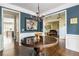 Elegant foyer with hardwood floors, large round table, chandelier, and views into other rooms at 1100 Lady Slipper Way, Canton, GA 30115