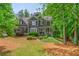 Charming two-story home featuring mature landscaping and a welcoming front porch at 1100 Lady Slipper Way, Canton, GA 30115